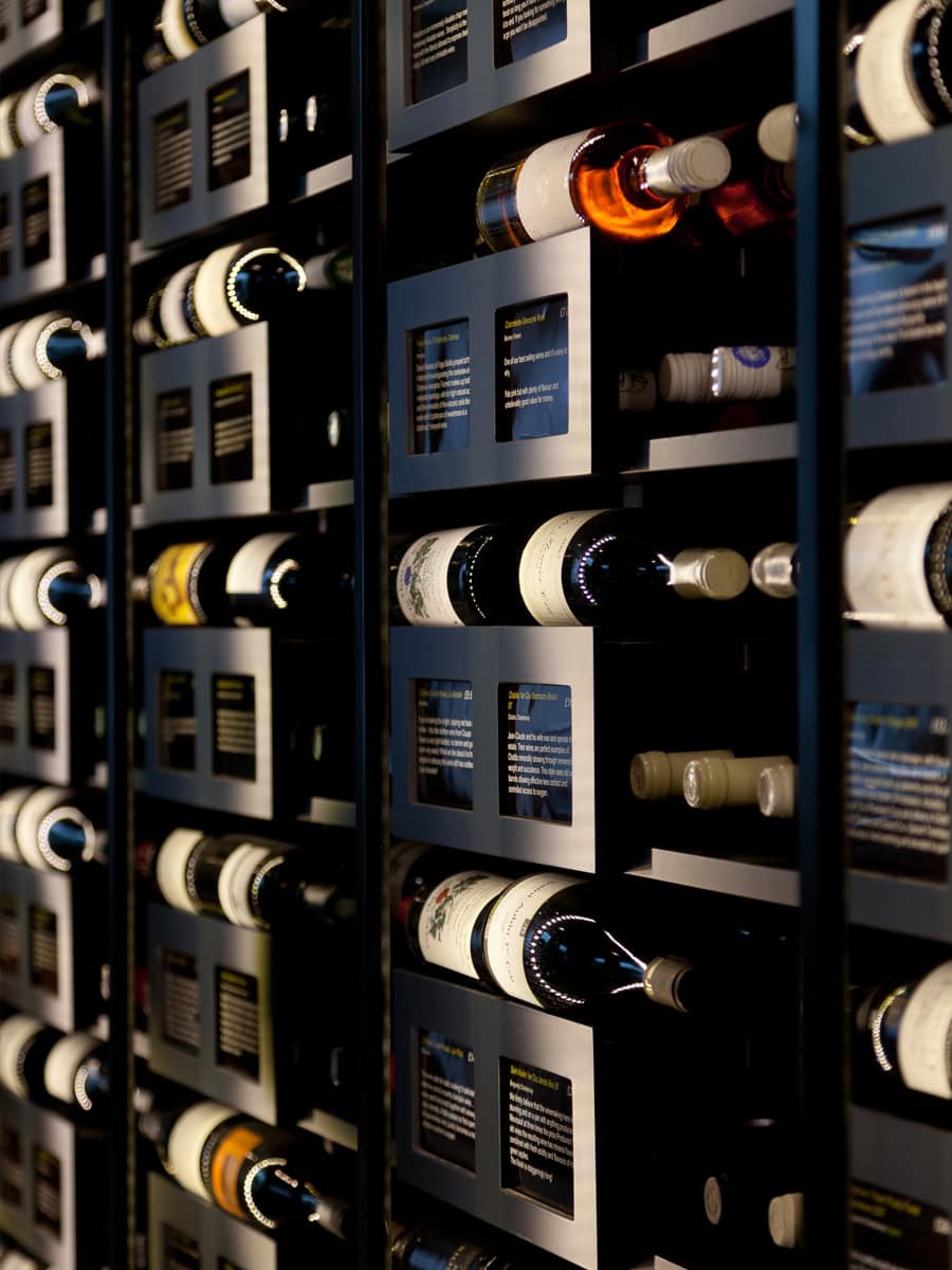 Oeno Wines Cirencester interior view, wine bottles on modular racking with concealed LED lighting